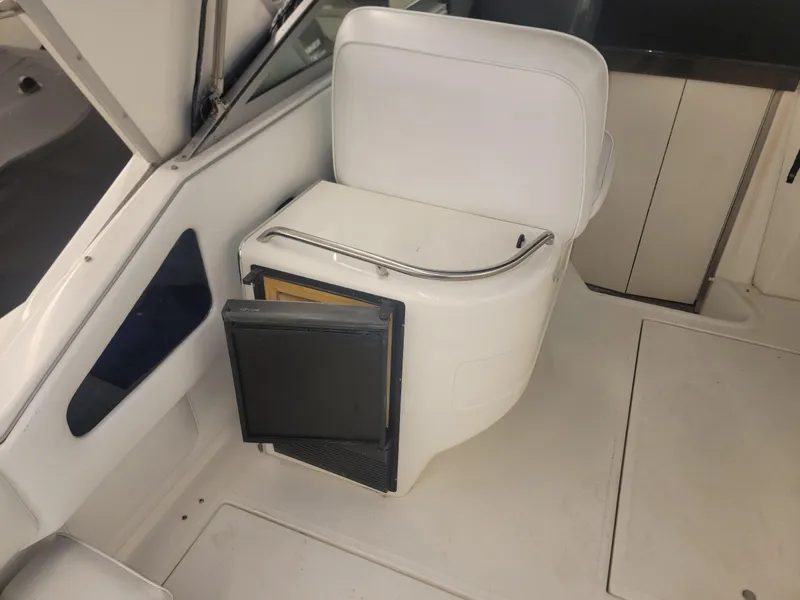 Slide: The Image of Interior of a 1992 Sea Ray 330 Sundancer boat with white seating and storage. - 20