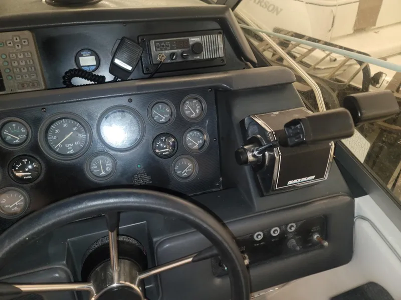 Slide: The Image of Control panel of a 1992 Sea Ray 330 Sundancer boat with gauges and steering wheel. - 28
