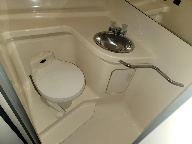 Slide: The Image of Compact bathroom in 1992 Sea Ray 330 Sundancer with toilet, sink, and handrail. - 44
