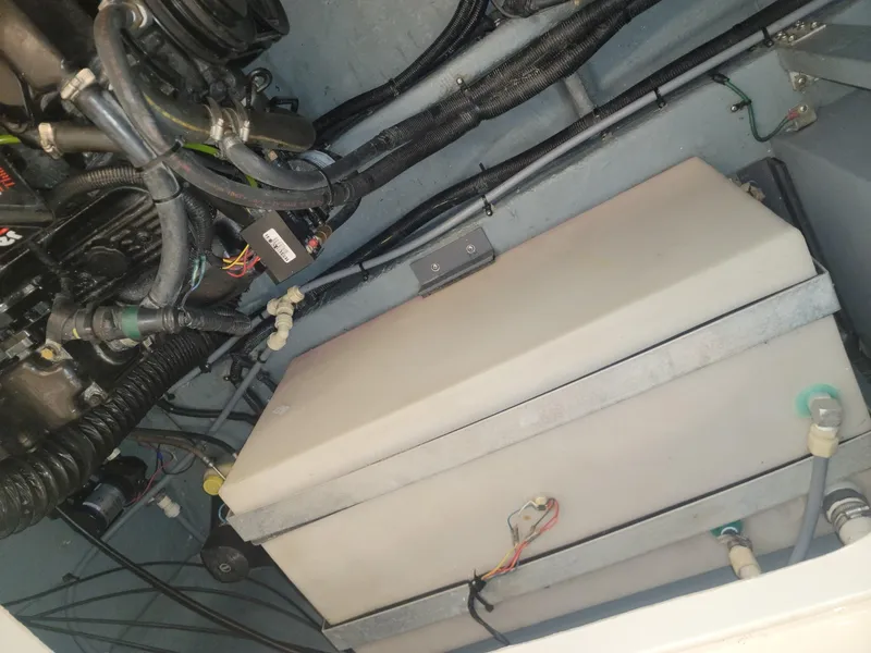 Slide: The Image of Engine compartment of a 1992 Sea Ray 330 Sundancer boat showing hoses and components. - 46