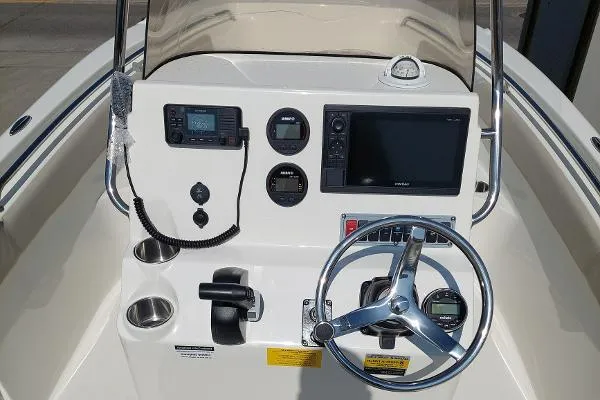 Slide: The Image of 2023 Key West 203 FS boat dashboard with steering wheel, gauges, and navigation system. - 6