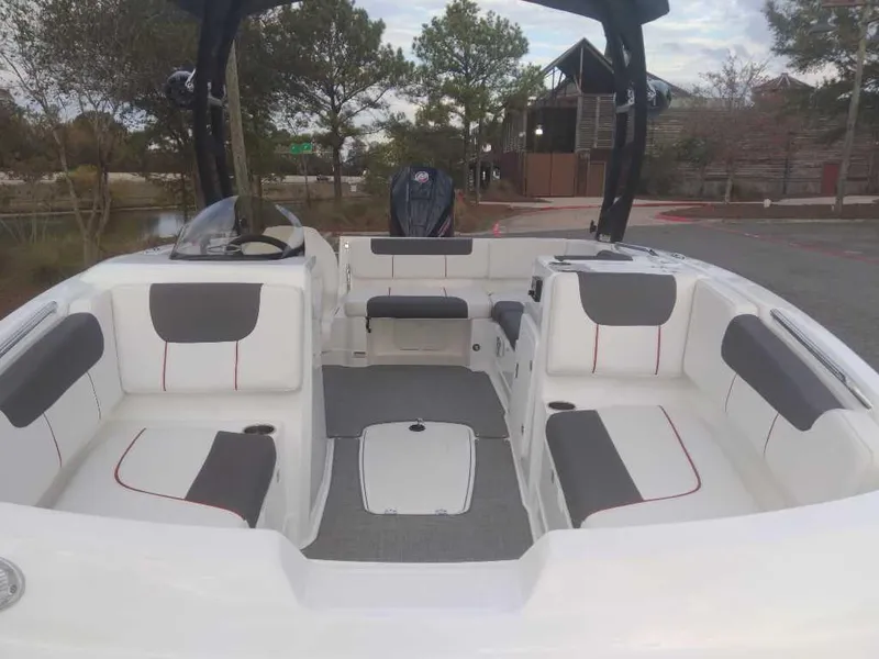 Slide: The Image of 2023 Tahoe 1950 boat interior with white and gray seating, outdoor setting. - 11