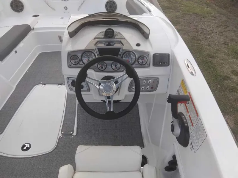 Slide: The Image of Steering console of a 2023 Tahoe 1950 boat with modern controls and gauges. - 18