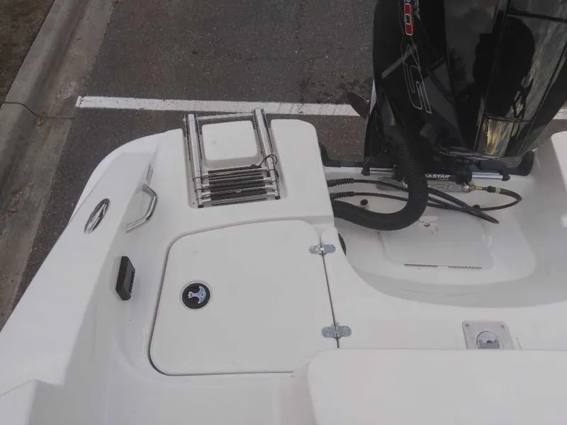 Slide: The Image of 2023 Tahoe 1950 boat stern with outboard motor and swim ladder. - 20