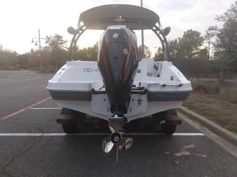 Slide: The Image of 2023 Tahoe 1950 boat with outboard motor in parking lot. - 4