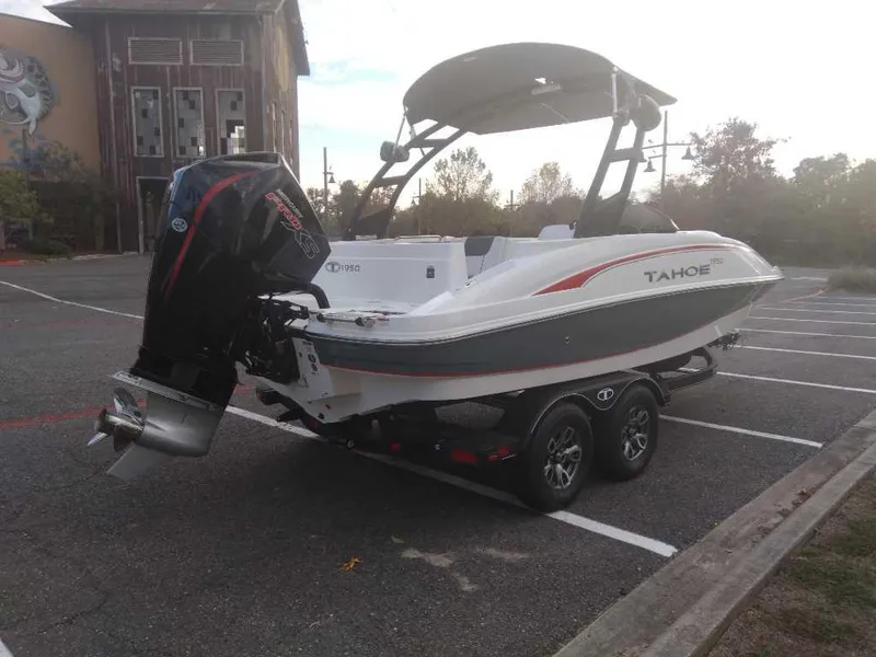 Slide: The Image of 2023 Tahoe 1950 boat on trailer in parking lot. - 5