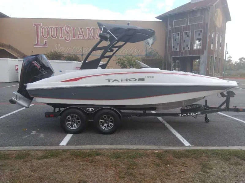 Slide: The Image of 2023 Tahoe 1950 boat on trailer in parking lot. - 7