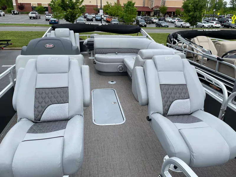 Slide: The Image of 2023 Ranger 223F boat interior with plush gray seating and modern design. - 4