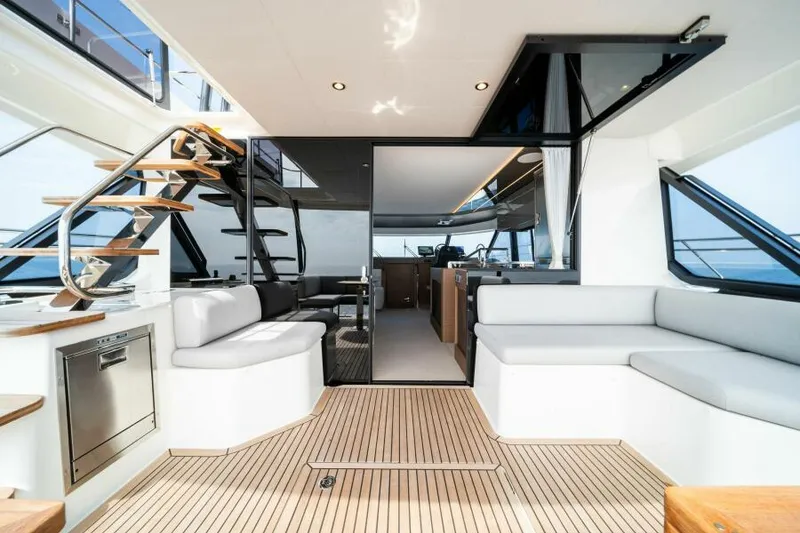 Slide: The Image of Luxurious interior of 2025 Prestige M48 yacht with modern seating and wooden flooring. - 4