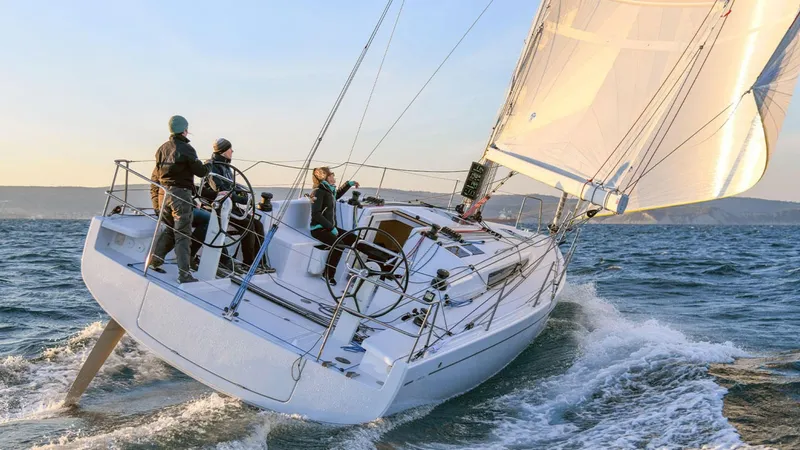 Slide: The Image of 2024 Beneteau First 36 sailboat navigating the ocean with crew. - 3