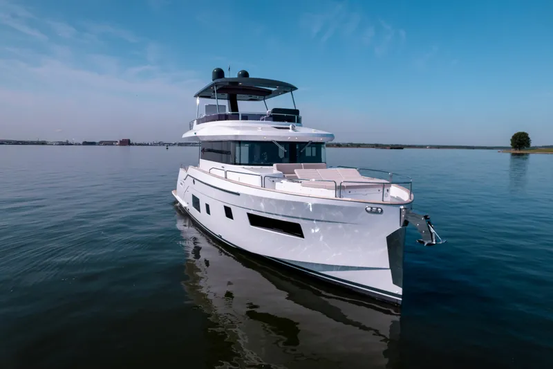 Slide: The Image of 2025 Sirena 58 yacht cruising on calm waters under a clear blue sky. - 10