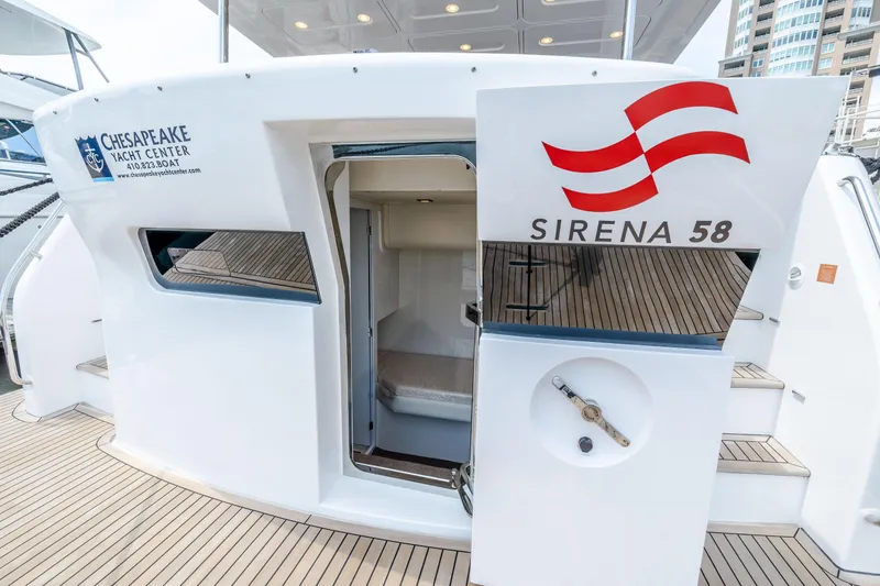 Slide: The Image of 2025 Sirena 58 yacht stern view with open door and Chesapeake Yacht Center logo. - 12