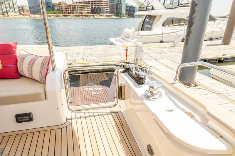 Slide: The Image of Luxury Sirena 58 yacht deck, 2025 model, docked at marina with waterfront view. - 17