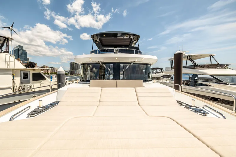 Slide: The Image of 2025 Sirena 58 yacht docked at marina with sunbathing area. - 20