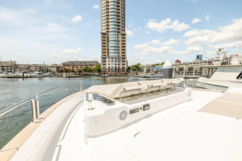 Slide: The Image of Sirena 58 yacht deck with cityscape and marina view, 2025 model. - 22