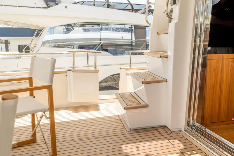 Slide: The Image of Luxury yacht Sirena 58, 2025 model, featuring elegant deck and staircase. - 25