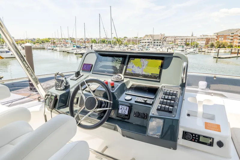 Slide: The Image of Helm station of 2025 Sirena 58 yacht with advanced navigation systems in a marina. - 28