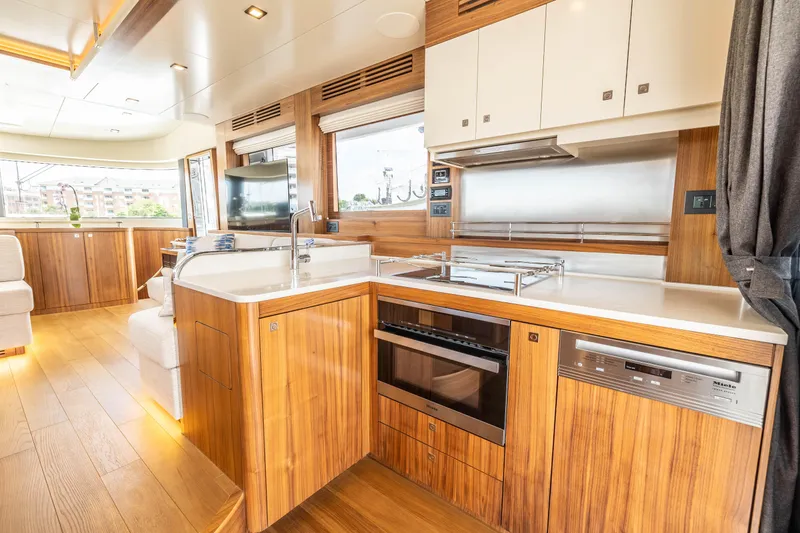 Slide: The Image of Modern kitchen interior of 2025 Sirena 58 yacht with wooden cabinetry and stainless steel appliances. - 33