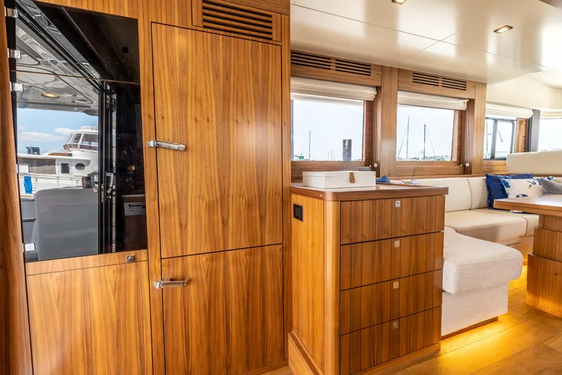 Slide: The Image of Interior of 2025 Sirena 58 yacht with wooden cabinetry and seating area. - 34
