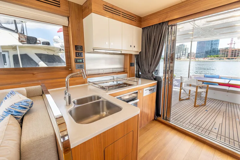 Slide: The Image of Modern kitchen and dining area on the 2025 Sirena 58 yacht, with waterfront view. - 36