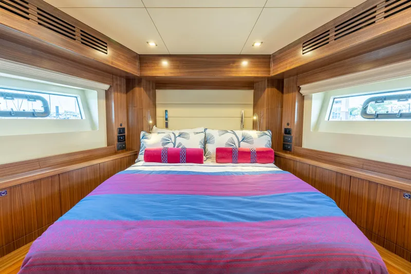 Slide: The Image of Luxurious bedroom interior of 2025 Sirena 58 yacht with large bed and wooden accents. - 43