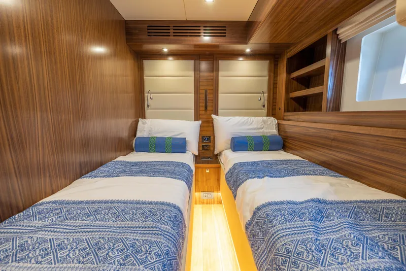 Slide: The Image of Twin beds in the 2025 Sirena 58 yacht cabin with wooden interior. - 47