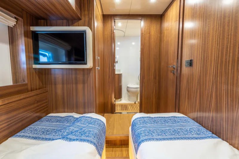 Slide: The Image of Interior cabin of 2025 Sirena 58 yacht with twin beds and TV. - 48