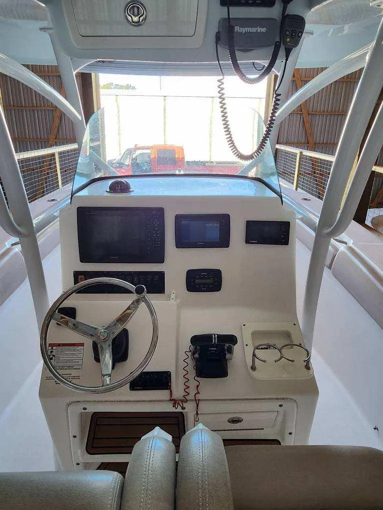 Slide: The Image of 2015 Sea Fox 286 Commander boat helm with steering wheel and navigation equipment. - 14