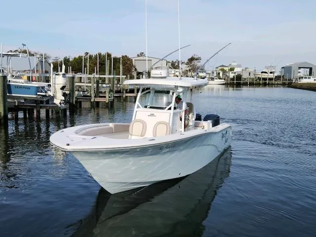 Slide: The Image of 2015 Sea Fox 286 Commander boat cruising in a marina. - 2