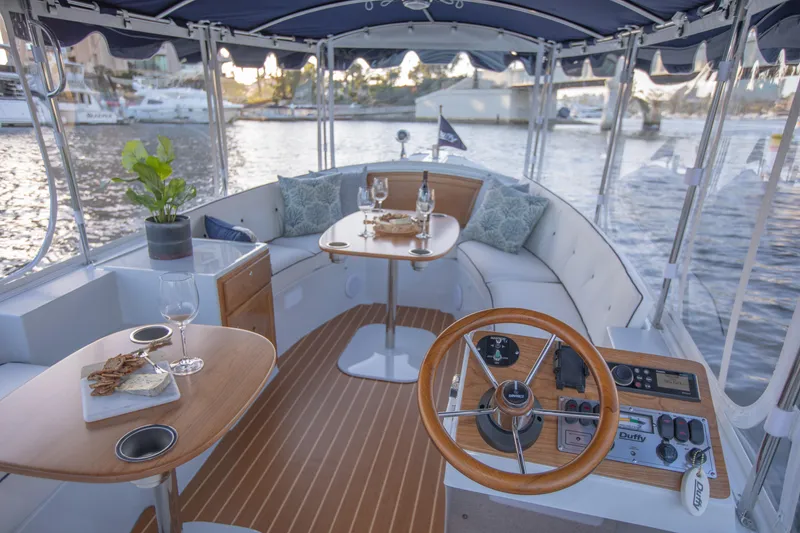 Slide: The Image of 2022 Duffy Snug Harbor 18 interior with elegant seating and dining area on the water. - 7