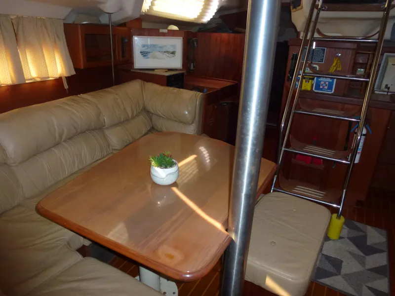 Slide: The Image of Interior of 2001 Hunter 420 Passage sailboat with dining area and ladder. - 18