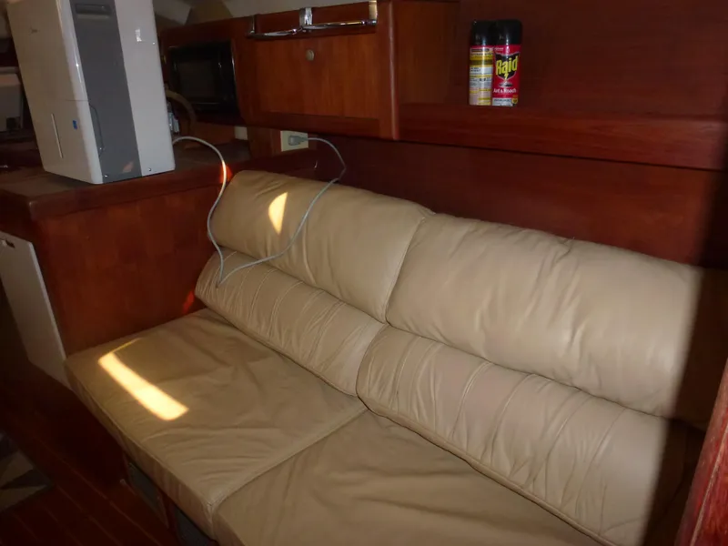 Slide: The Image of Interior of 2001 Hunter 420 Passage yacht with beige leather sofa and wooden cabinetry. - 19