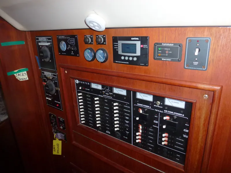 Slide: The Image of Control panel of a 2001 Hunter 420 Passage sailboat with various gauges and switches. - 29