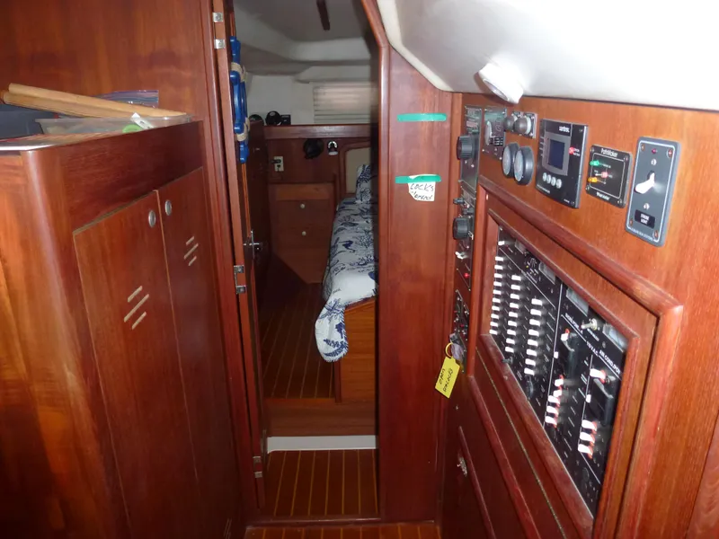 Slide: The Image of Interior of 2001 Hunter 420 Passage sailboat with wood paneling and control panels. - 30