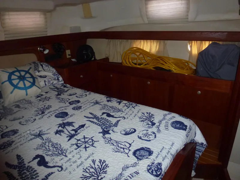 Slide: The Image of Cozy cabin interior of 2001 Hunter 420 Passage sailboat with nautical-themed bedding. - 33