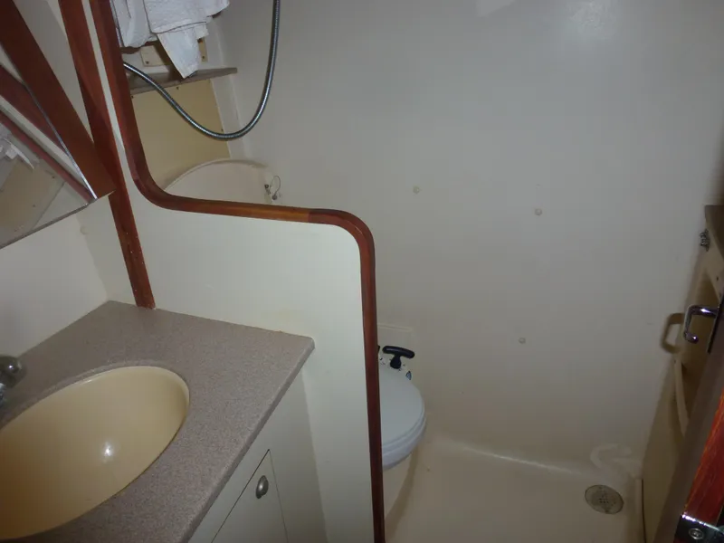 Slide: The Image of 2001 Hunter 420 Passage bathroom with sink, toilet, and shower. - 34