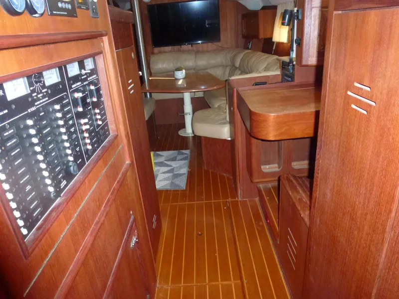 Slide: The Image of Interior of 2001 Hunter 420 Passage sailboat with wood paneling and cozy seating area. - 36