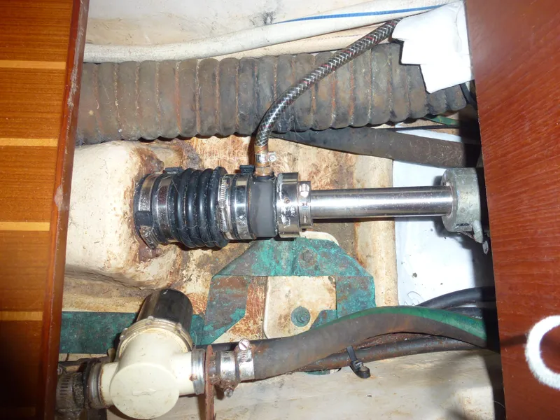 Slide: The Image of 2001 Hunter 420 Passage boat engine compartment with propeller shaft and hoses. - 37