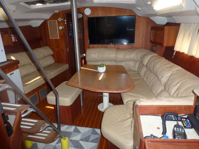 Slide: The Image of Interior of 2001 Hunter 420 Passage sailboat with leather seating and wooden table. - 38