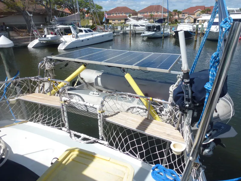 Slide: The Image of Hunter 420 Passage 2001 sailboat with solar panels and dinghy at marina. - 7