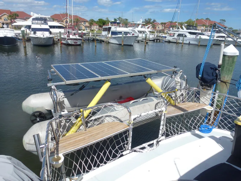 Slide: The Image of Hunter 420 Passage 2001 sailboat with solar panels docked at a marina. - 8
