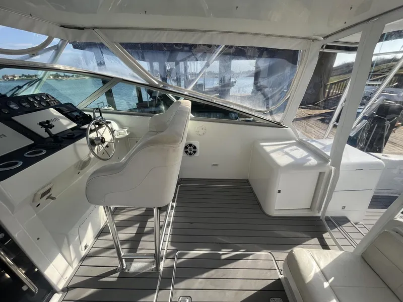 Slide: The Image of 1993 Bertram 46 Moppie boat interior with helm station and seating. - 13