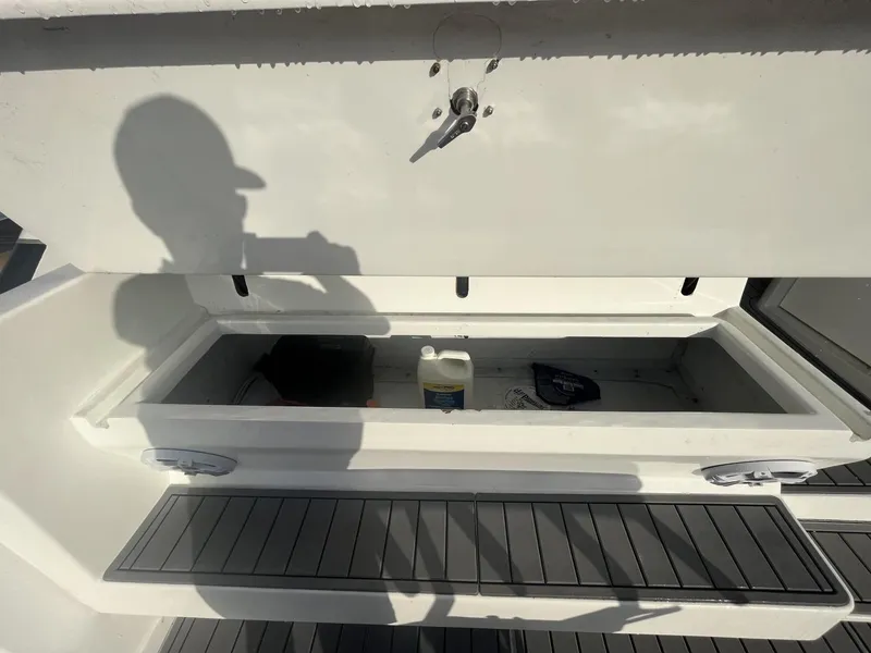 Slide: The Image of Storage compartment on a 1993 Bertram 46 Moppie boat with cleaning supplies. - 16