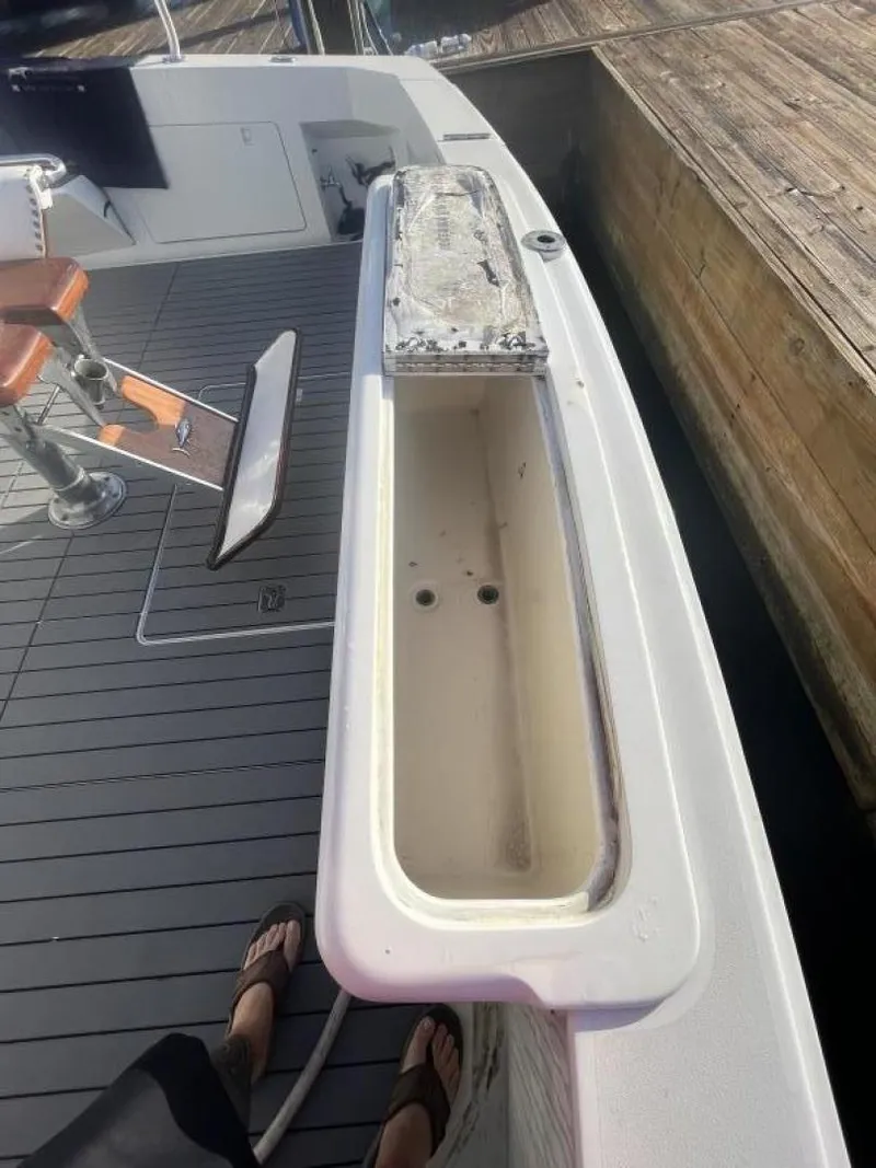 Slide: The Image of 1993 Bertram 46 Moppie boat deck with seating and storage compartment. - 17