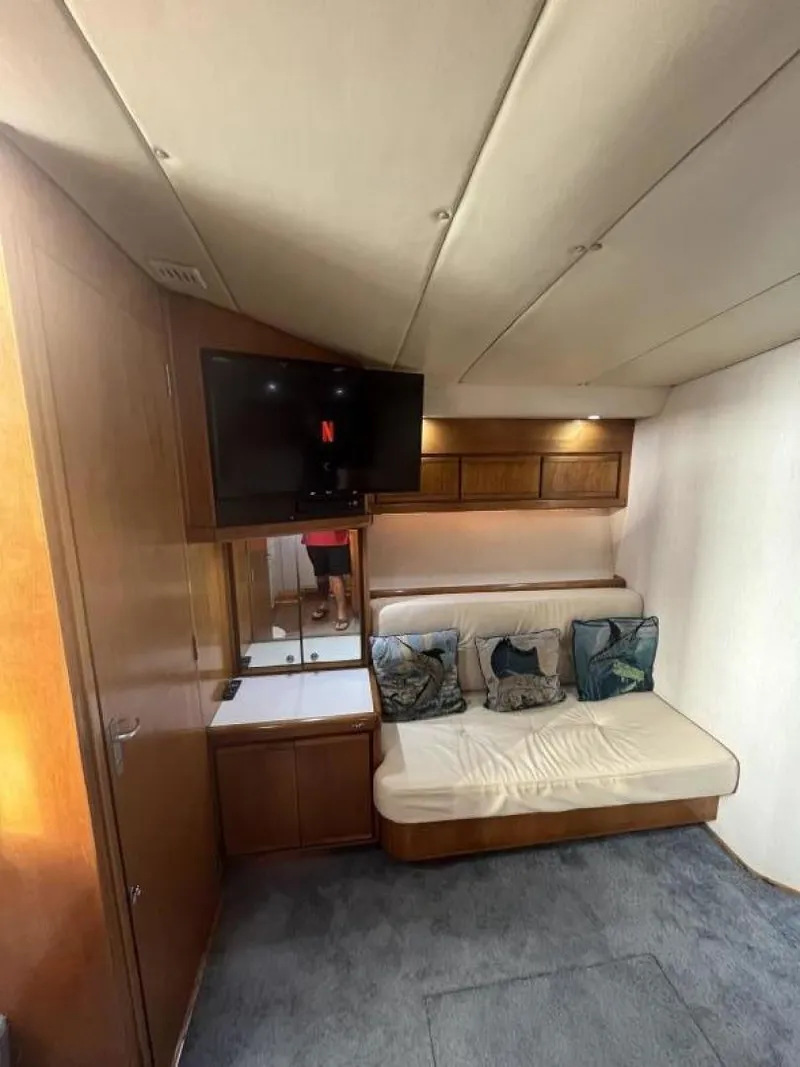 Slide: The Image of Interior of 1993 Bertram 46 Moppie yacht with sofa, TV, and wooden cabinets. - 5