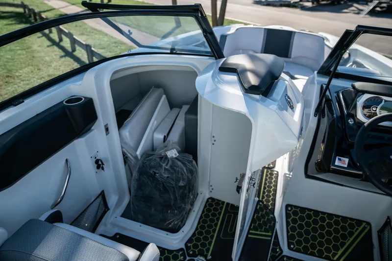 Slide: The Image of 2022 Scarab 255 boat interior with open storage compartment and seating area. - 14