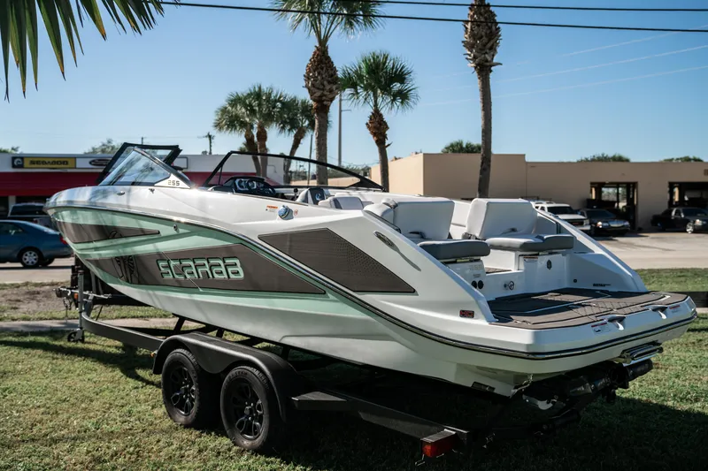 Slide: The Image of 2022 Scarab 255 boat on trailer, parked outdoors. - 5