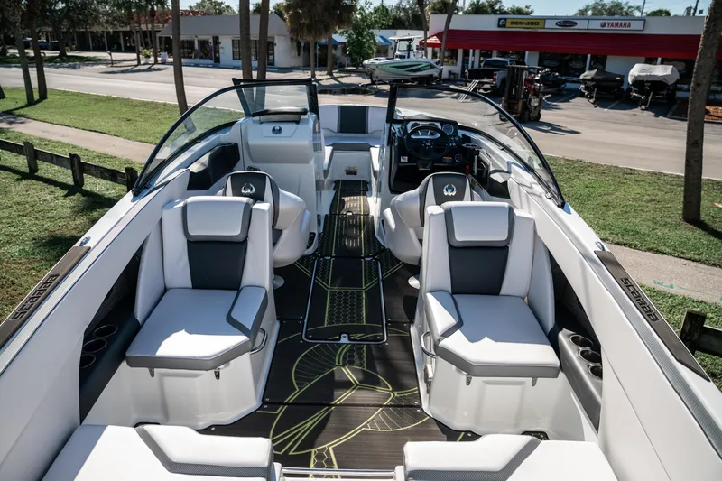 Slide: The Image of 2022 Scarab 255 boat interior with white and gray seating, modern dashboard, and spacious layout. - 9