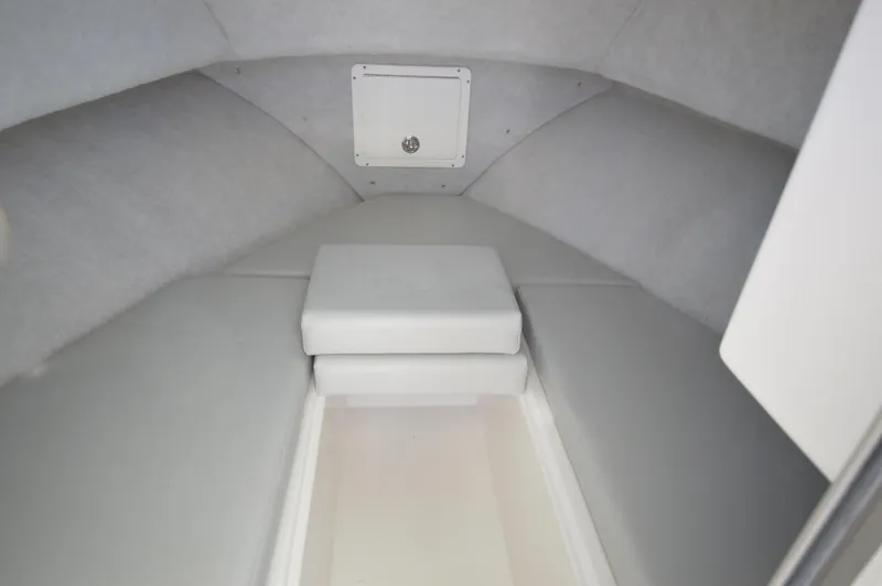 Slide: The Image of 2023 May-Craft 23 Pilothouse interior cabin with cushioned seating. - 11