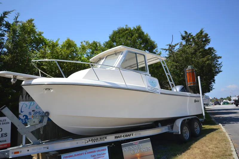 Slide: The Image of 2023 May-Craft 23 Pilothouse boat on a trailer, parked outdoors. - 2